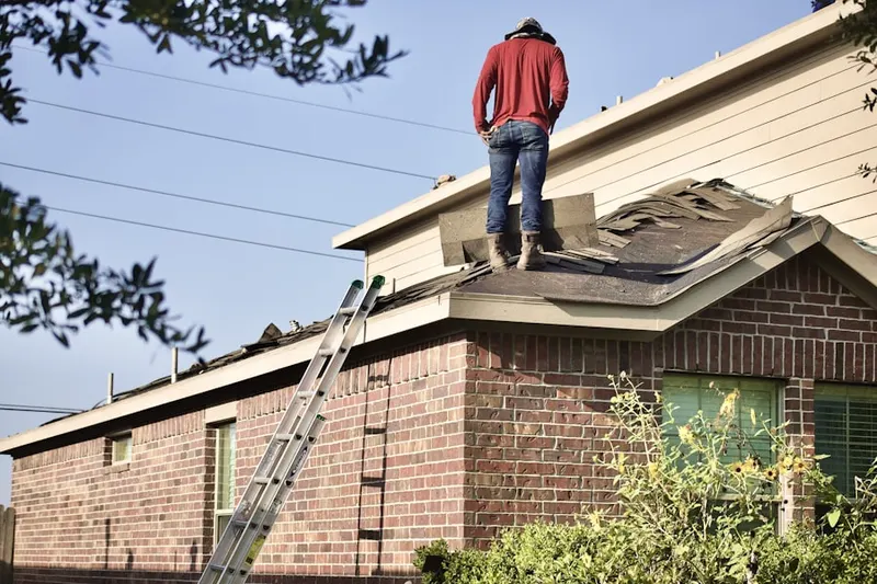 Professional roofer working on a residential roof in Raintree Lake South